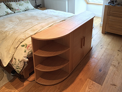 End of bed pop up television cabinet in oak